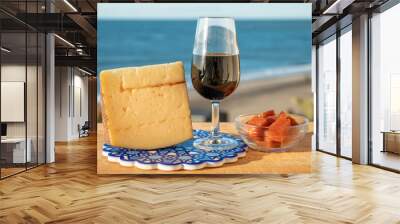 Tasting of sweet Spanish fortified Pedro Ximenez sherry wine with manchego cheese made with same sherry wine in El Puerto de Santa Maria, Andalusia, Spain Wall mural