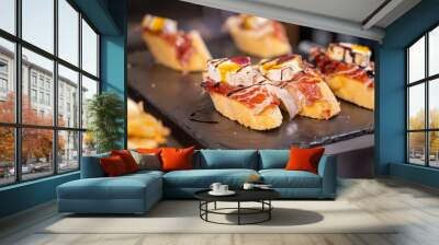 Typical snack of Basque Country and Navarre, pinchos or pinxtos served in bar, small slices of bread upon which ingredient or mixture of ingredients is placed, San Sebastian, Spain Wall mural