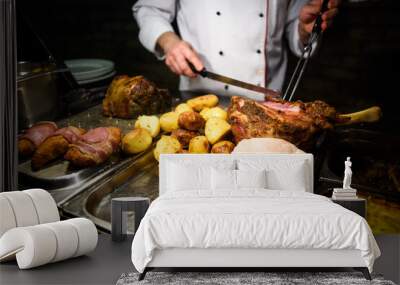 Detail of baked meat being cut with knife. Wall mural