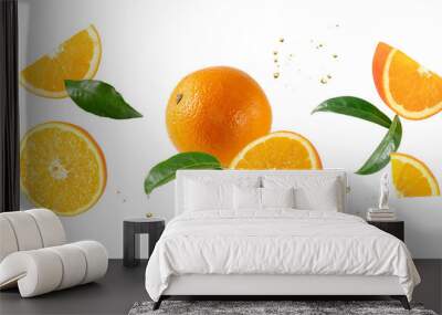 Fresh orange fruit whole and slices with leaves falling flying isolated on white Wall mural