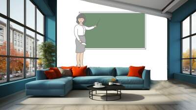 Young female teacher on lesson at blackboard in classroom. Teacher with pointer, teacher showing on board. Wall mural