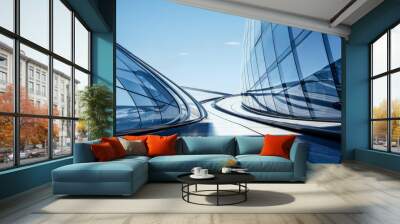 Modern architectural elegance: Upward view of a futuristic skyscraper's curved glass facade reflecting the clear blue sky Wall mural