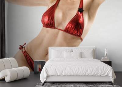 attractive blond model wearing red bikini on grey background Wall mural