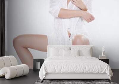 Young slim sexy woman in white sweater isolated on white backgro Wall mural