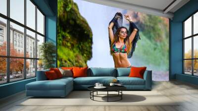 Sexy brunette model on water fall background , in sunglasses and bikini  Wall mural