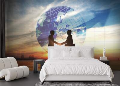 Two business man shake hand silhouettes city with global Wall mural