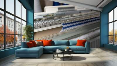 Manual knitting machine. A knitting machine is a device used to create knitted fabrics Wall mural