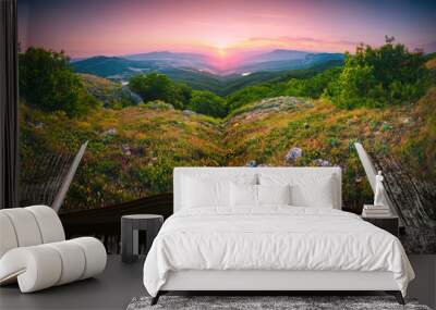 Sunset in a valley on the pages of an open book Wall mural