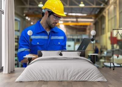 Professional heavy industry engineer worker wearing safety uniform and hard hat uses tablet computer. Wall mural