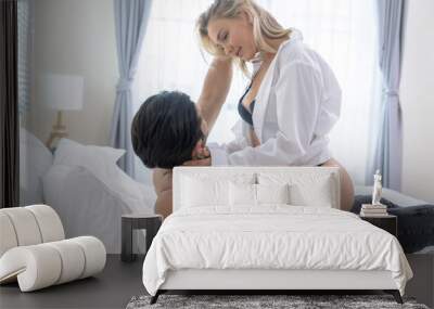 Young caucasian couple having passionate sex in bed Wall mural