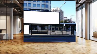 A city street, a bus stop with a long large blank advertisement display of white color, no people in the image Wall mural