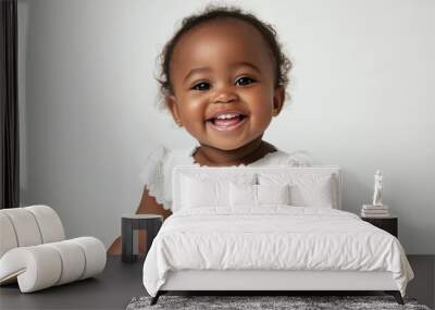 Portrait of Smiling African toddler girl in white dress, sitting with a wide smile ,isolated on a pure white background Wall mural