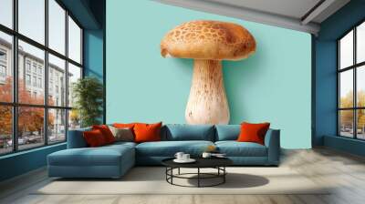 A detailed view of a golden-brown mushroom with a textured cap against a vibrant turquoise backdrop, celebrating the beauty of nature and food in an artistic composition Wall mural