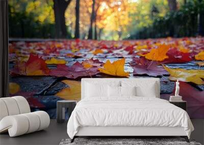 Colorful autumn leaves falling from the trees A picturesque park where the trees are decorated with bright red, orange and yellow leaves that gently fall to the ground. Wall mural