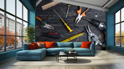 Various working tool on a dark wooden table. Wall mural