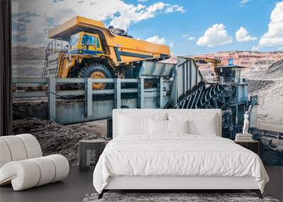 Big dump truck is mining machinery, or mining equipment to transport coal from open-pit or open-cast mine as the Coal Production. Loading of coal ore from dump truck to the crusher house. Wall mural