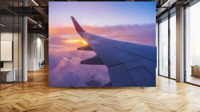 Beautiful sunset, sky on the top view, airplane flying view from inside window aircraft of Traveling. Wall mural