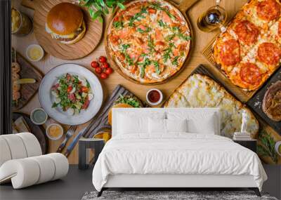 assorted foodset on table. Pizza Quattro formaggi on the Rome dough, pizza with parma ham, burges, shrimps, steak ribeye, french fries top view food. Wall mural