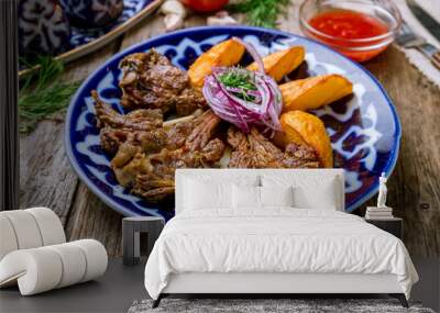 Kazan kebab on plate on wooden background Wall mural