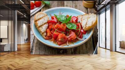 Tomato salad with red onion and bread on wooden table Wall mural