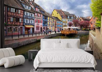 colmar, france. boat with tourists on canal in little venice (la petite venise) area Wall mural