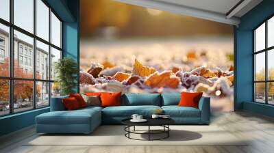 Autumn leaves covered in frost with the sun shining in the background. Wall mural