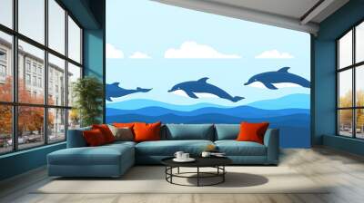 Three dolphins leaping out of the water against a blue sky with clouds. Wall mural