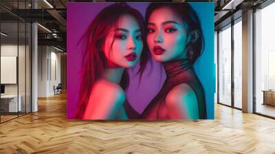 A vibrant night club image showcasing two beautiful Asian women dancing and posing glamorously together on the dance floor, illuminated by striking neon lights in a lively club atmosphere. Wall mural