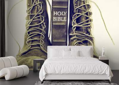 Bible and boots on gray background Wall mural