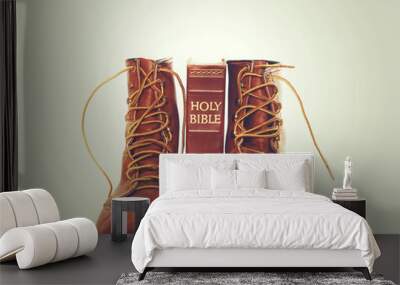 Bible and boots on gray background Wall mural