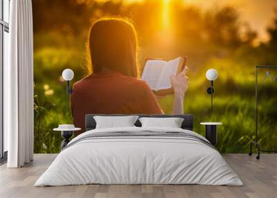 Girl reading the Bible at sunset Wall mural