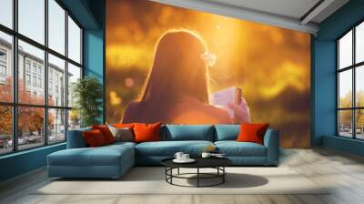 Girl reading the Bible at sunset Wall mural