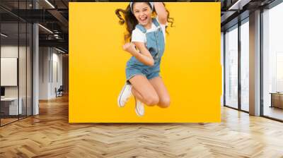 Active girl feel freedom. Fun and relax. feeling free. carefree kid on summer holiday. time for fun. retro beauty in mid air. Jump of happiness. small girl jump yellow background. full of energy. Wall mural