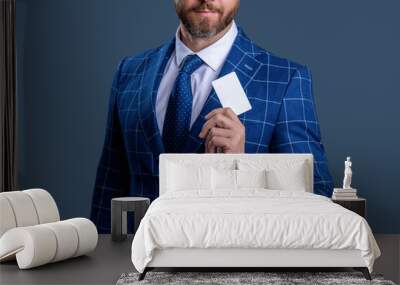 Businessman business man hold credit or debit card in suit isolated on grey, cropped view Wall mural