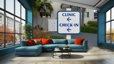 Clinic check-in inscription on sign post. Navigation sign. Wayfinding concept Wall mural