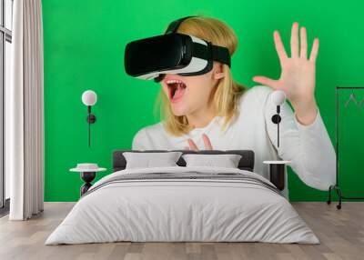 Confident young woman adjusting her virtual reality headset and smiling. Excited smiling businesswoman wearing virtual reality glasses. Woman VR. Wall mural