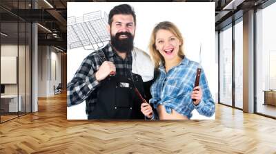 Family weekend. Couple in love hold cooking utensils for barbecue. Tools for roasting meat outdoors. Picnic and barbecue. Man bearded hipster and girl ready for barbecue party. Culinary concept Wall mural