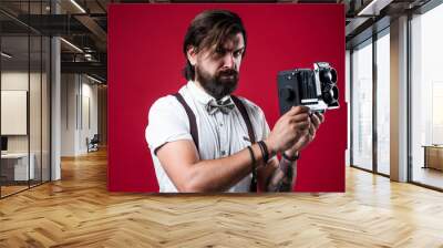 get a pose. elegant male hold retro camera. handsome hipster making vintage photo. mature journalist use old technology. bearded camera man in suspenders. brutal guy photographer wear bow tie Wall mural