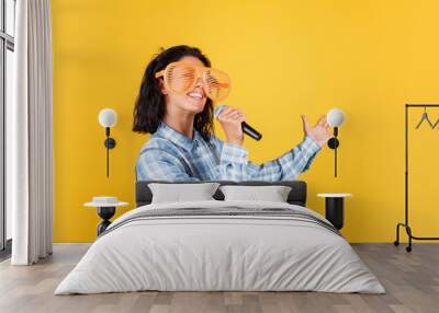 happy pretty woman with brunette hair wear casual clothes sing song in microphone, karaoke Wall mural