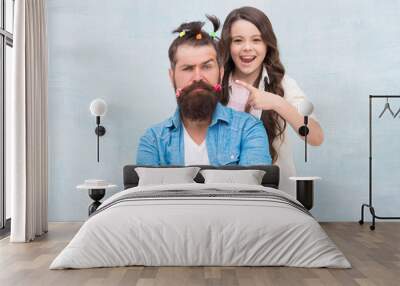 I did it. little girl made funny hairstyle for daddy. daughter and dad playing together. hairstylist her future career. father enjoying time with child. togetherness. spending time together at home Wall mural