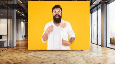 Love is in air. love heart for valentines day holiday. happy birthday. brutal man with beard fall in love. romantic date. happy male hipster in party glasses. bearded man hipster yellow background Wall mural