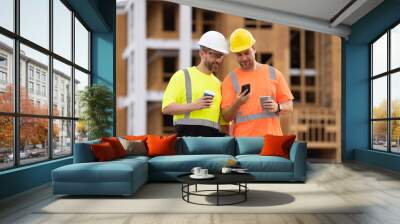 photo of engineer men using phone at construction site. engineer men at construction site. Wall mural