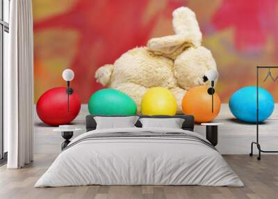 rabbit toy, painted easter eggs on colorful background Wall mural