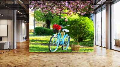 season of love. beauty of spring. retro bicycle with tulip flowers in basket. vintage bike in park. sakura blossom in spring garden. nature full of colors and smells. relax and travel. romantic date Wall mural