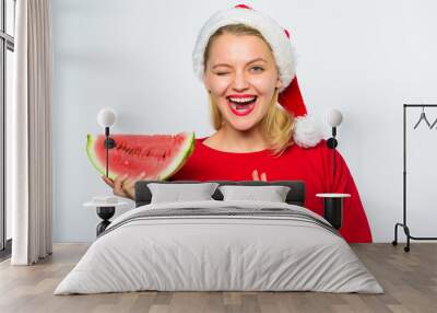 Summer treats on christmas party. Exotic christmas concept. Christmas girl eat watermelon. Exotic winter vacation. Celebrate new year summer. Girl wear santa hat eat slice watermelon white background Wall mural