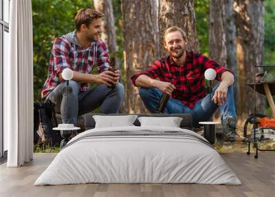 two men relax in forest. hiking and camping. male friendship. man best friend drink beer. ranger at outdoor activities. spend picnic weekend in nature. Tourism concept. hike and people Wall mural