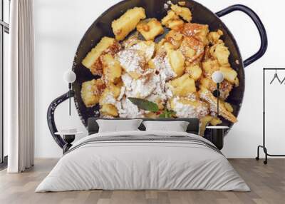 Kaiserschmarrn sugared in black iron pan isolated on white Wall mural