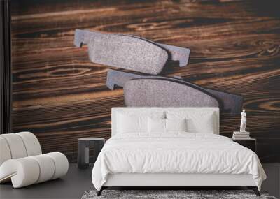 Studio photo of new car brake pads on a wooden background. Wall mural