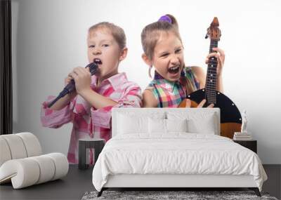 Two cute little girls posing with a microphone and domra. Wall mural