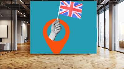 Art collage, the hand with the UK flag with the Navigation icon on a blue background. Wall mural